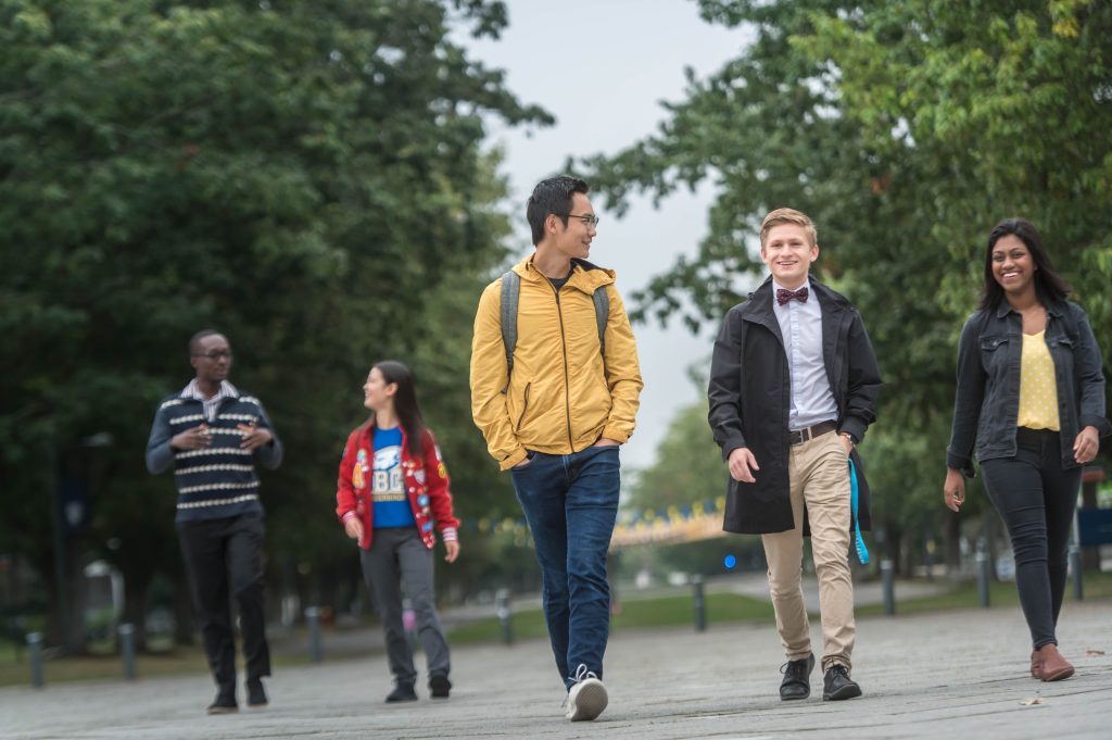 Students and staff walk along Main Mall at UBC Vancouver